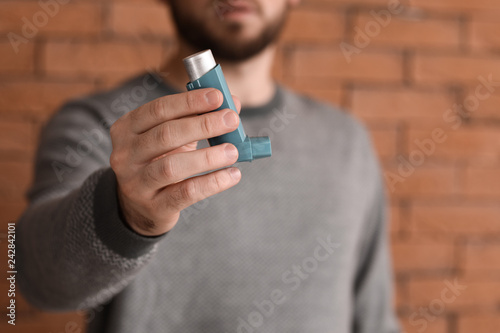 Young man with inhaler agai...