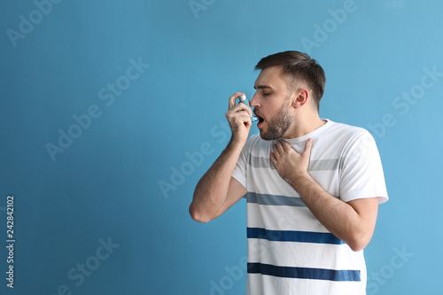 Young man with inhaler havi...
