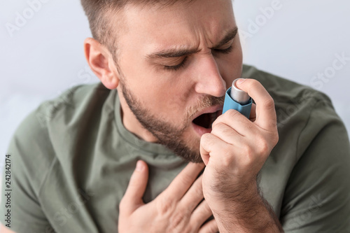 Young man with inhaler havi...