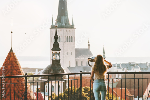 Young woman traveling in Tallinn city vacations in Estonia weekend Lifestyle outdoor girl tourist sightseeing St Olav's Church Old Town architecture