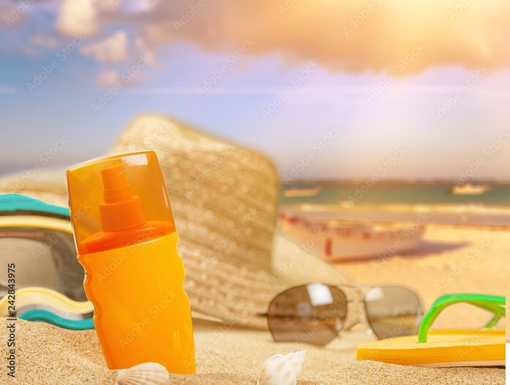 Bottle of sunscreen lotion on the sandy beach Bottle of sunscreen lotion on the sandy beach