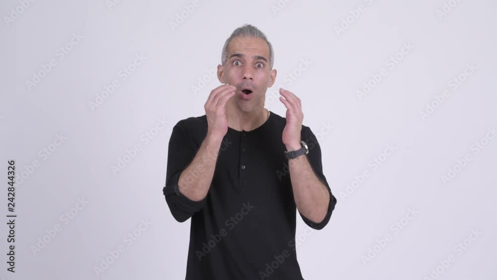 Handsome Persian man looking shocked against white background Handsome Persian man looking shocked against white background