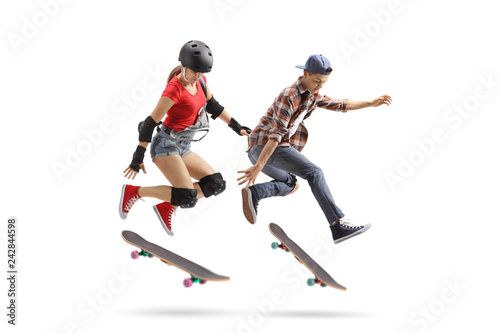 Female and male skaters performing a trick with a skateboard