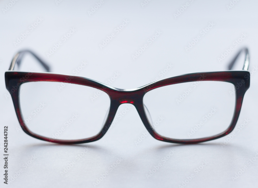corrective glasses in dark frame on white background, stylish accessory