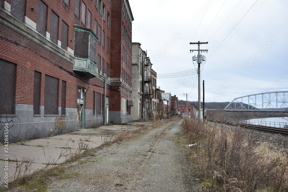 Depressed grunge rust belt town with abandoned brick buildings and street car tracks Brownsville Pennsylvania