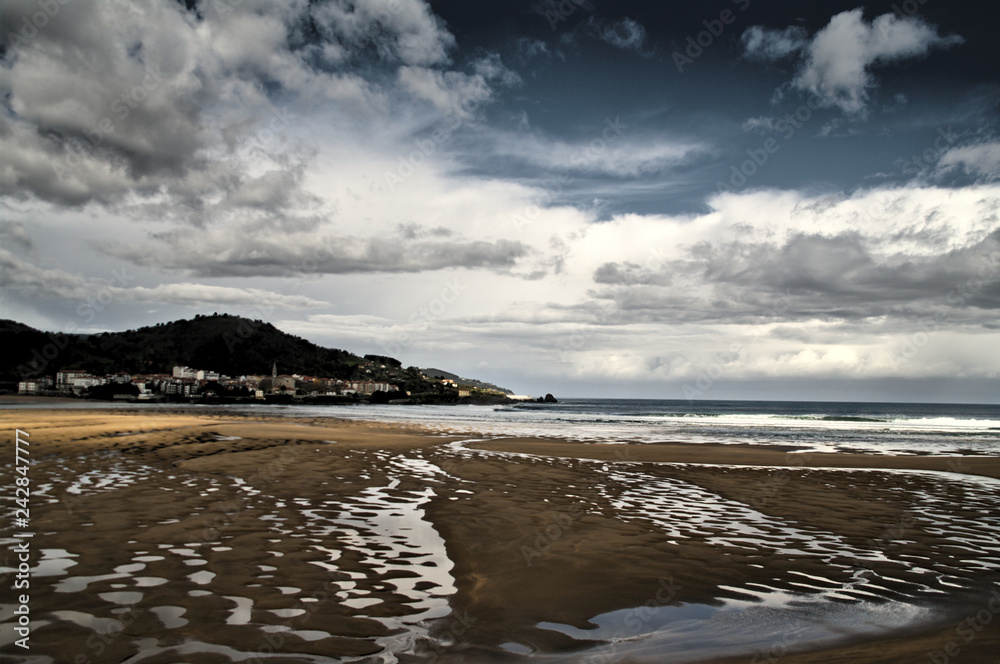 Landscape of beach, mountain and cloudy sky