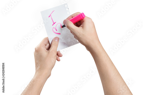 Hands writing a love note using a pink marker, isolated on white background