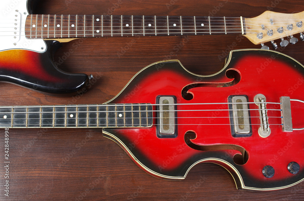 Two electric guitars on a wooden table Two electric guitars on a wooden table