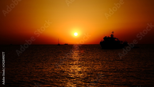 sunset at sea with yacht