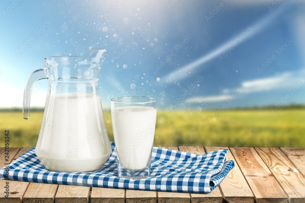 Glass of milk and bottle on background Glass of milk and bottle on background