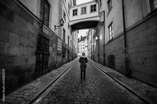 woman alone in old town of Gamla Stan  Stockholm  Sweden