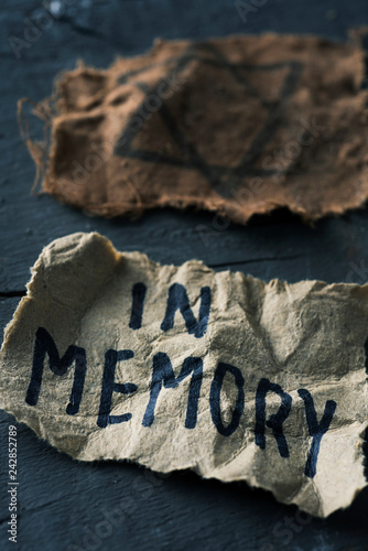 jewish badge and text in memory in piece of paper photo