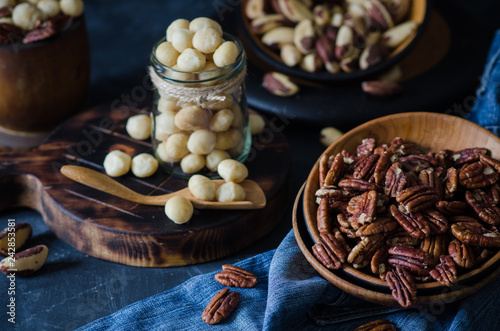Variety of nuts: macadamia, pecan and brazil nuts in rustic style