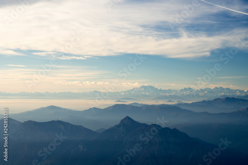 Panoramic view of the Italian Alps with fog on the Padana plain, Monte Rosa in the background. Viewpoint from the summit of Monte Resegone, Lombardy. Italian Landscape. © Arcansél