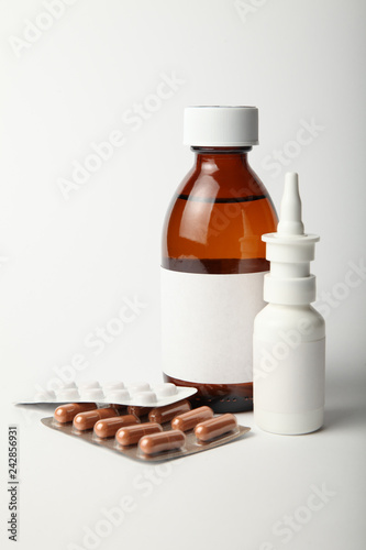 Set of cold medicine and flu virus on white background.