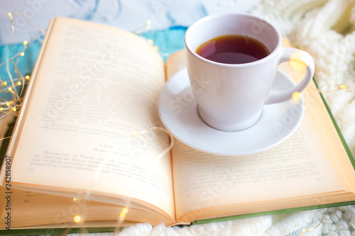 white cup on the book. Romantic breakfast in bed for Valentine's Day or Mother's Day 