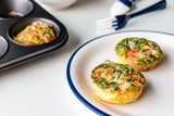 Healthy breakfast egg muffins with cheese, tomato and green vegetable, easy and healthy food concept