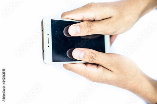 Close up of human hand holding a smart cell phone with two hands and using it.