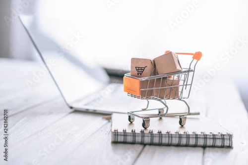 close up of packages in decorative cart on wooden desk