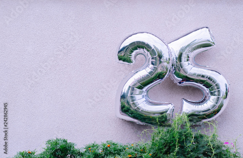 Balloons figures 25 on a beige background. photo