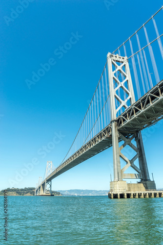 looking up at the San Francisco Bay Bridge from the water