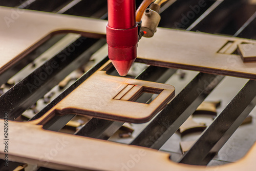 Laser engraver working and engraving wooden board