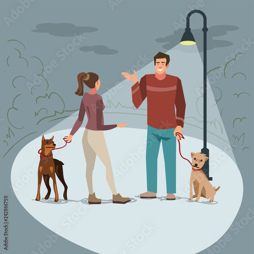 Young people walk in the park with their dogs in the evening when lighted lanterns.
