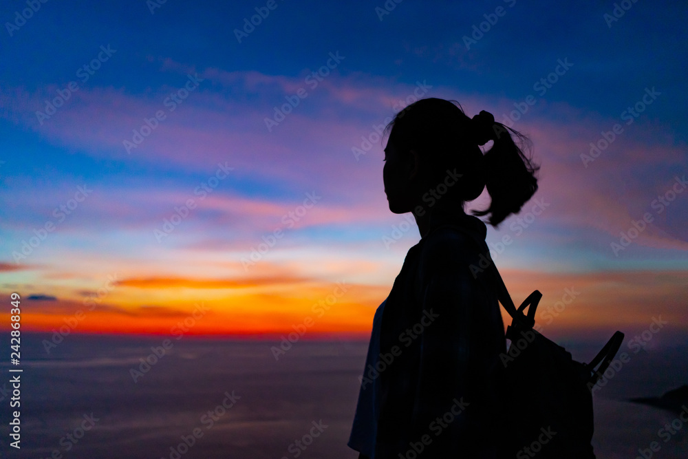 Traveler girl at dusk in Phuket, Thailand.