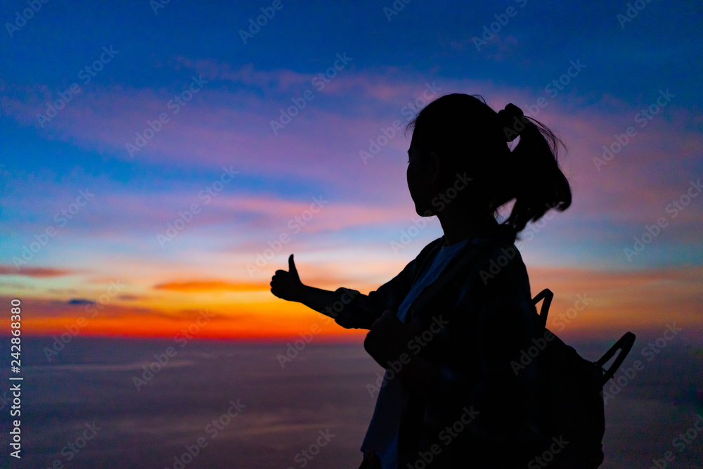Traveler girl at dusk in Phuket, Thailand.