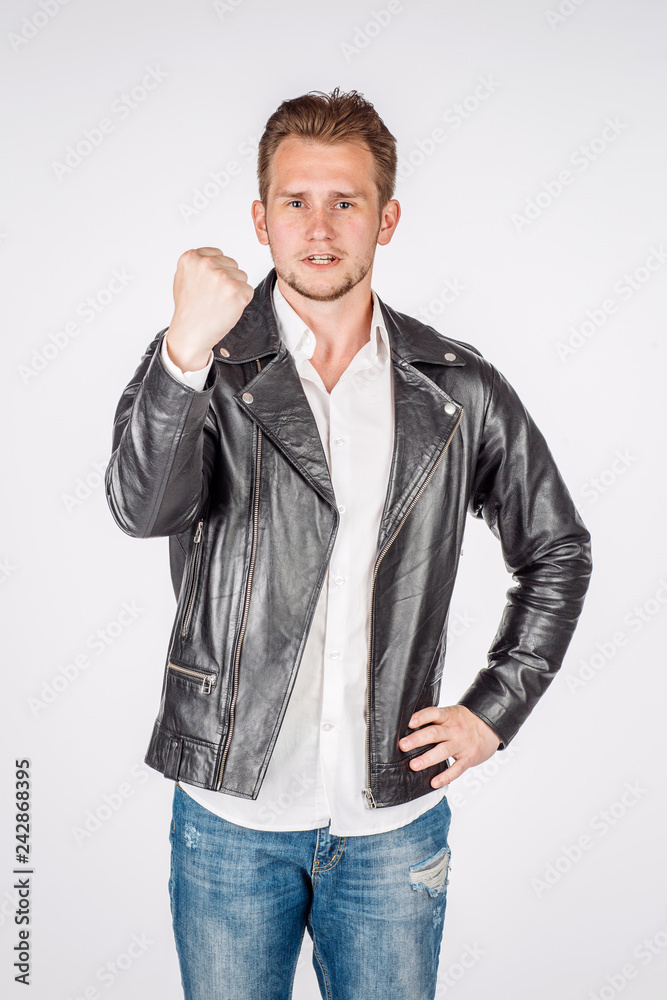 portrait of young man in black eather jacket isolated on a white background. Emotion and people concept.