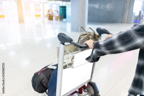 Traveler girl with airport cart.