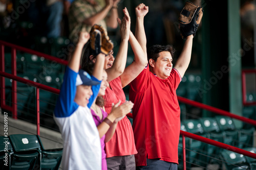 Family cheering on a baseball game at a sports stadium. photo