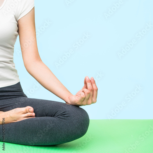 Close up hands. Woman do yoga. Woman exercising vital and meditation for fitness lifestyle club at the blue background Copy Space. Healthy and Yoga Concep