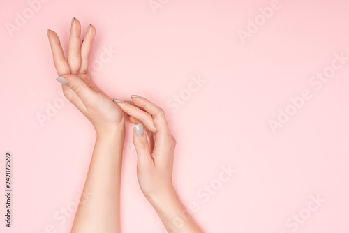 cropped view of female hands isolated on pink with copy space