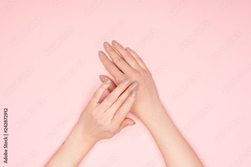 top view of female hands isolated on pink