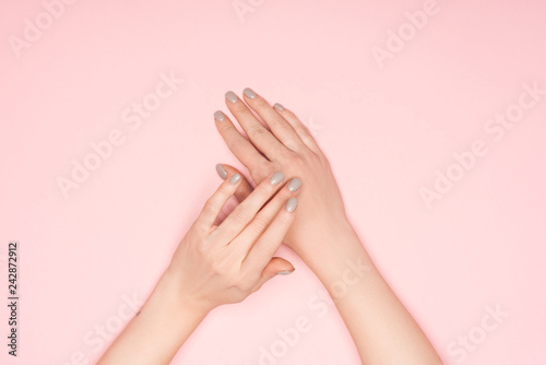 top view of female hands isolated on pink