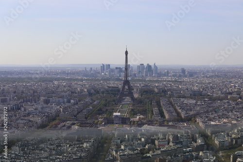 Top view of the streets and buildings of Paris and the Eiffile Tower © kazanovskyiphoto