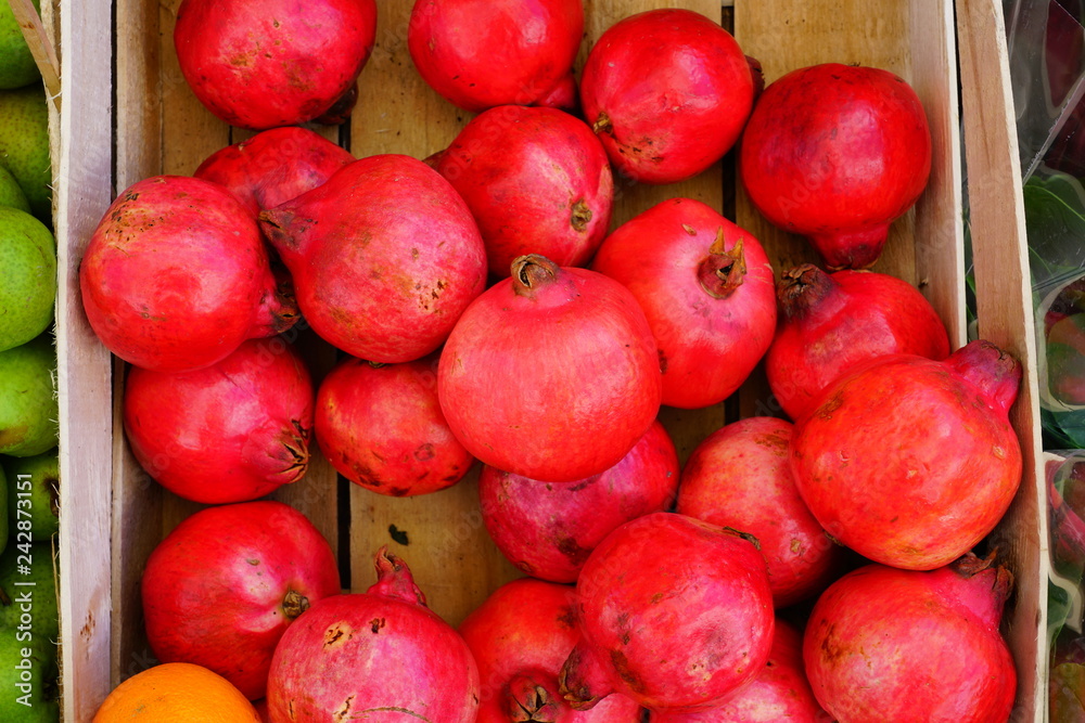 Crate of fresh red pomegranate fruit Crate of fresh red pomegranate fruit