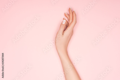 top view of female hand isolated on pink with copy space