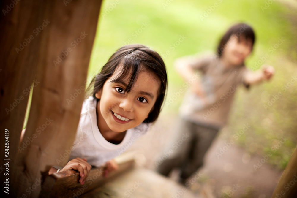 Kids playing in a treehouse. Kids playing in a treehouse.