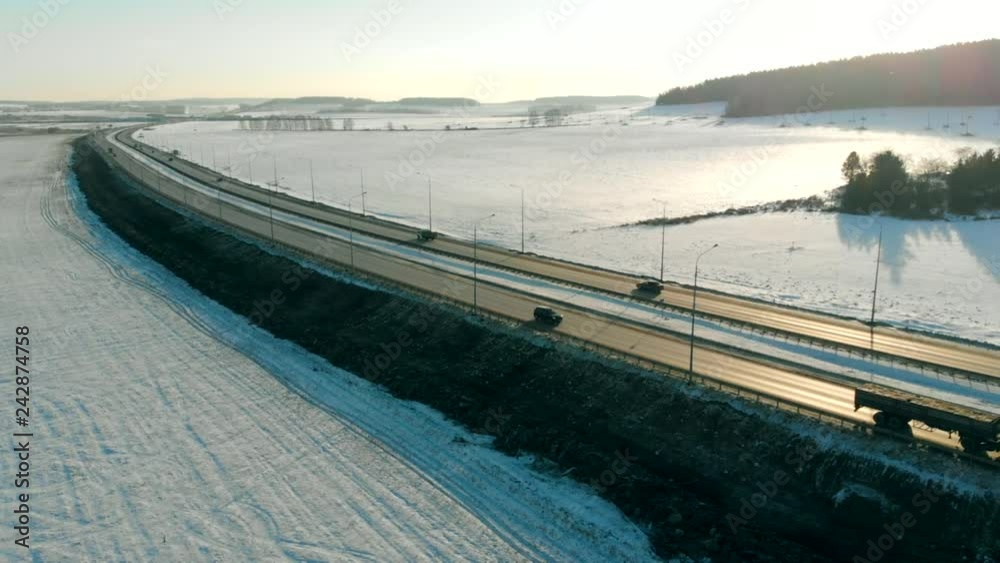custom made wallpaper toronto digitalAerial view of a snowy road through snow field with a car moving in winter. Top view of winter road in January, cold weather sunny day.