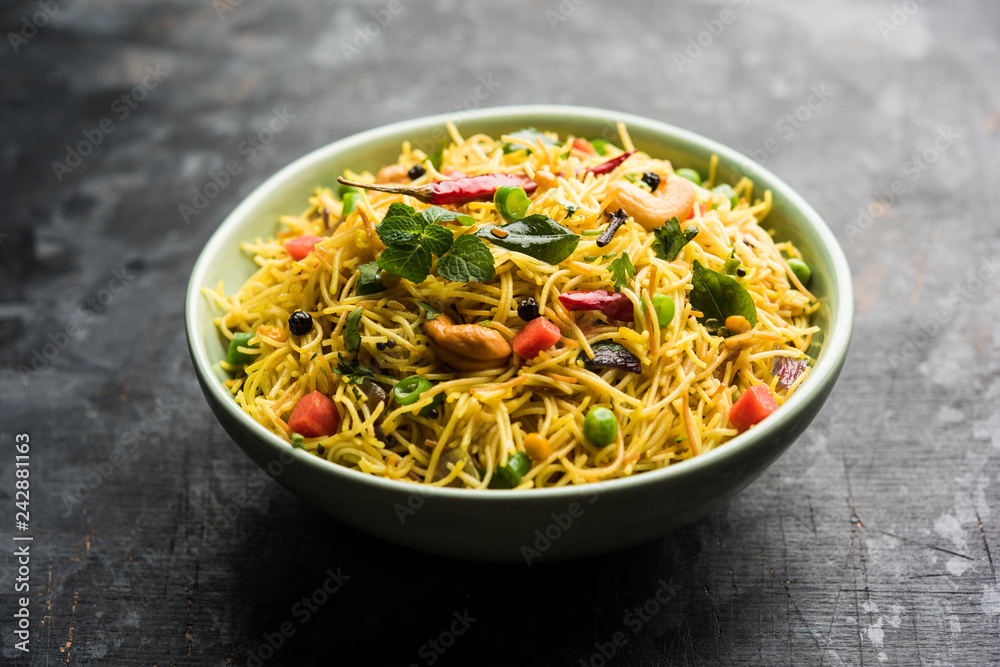 Spicy semiya uppma or upma served in plate. selective focus Spicy semiya uppma or upma served in plate. selective focus
