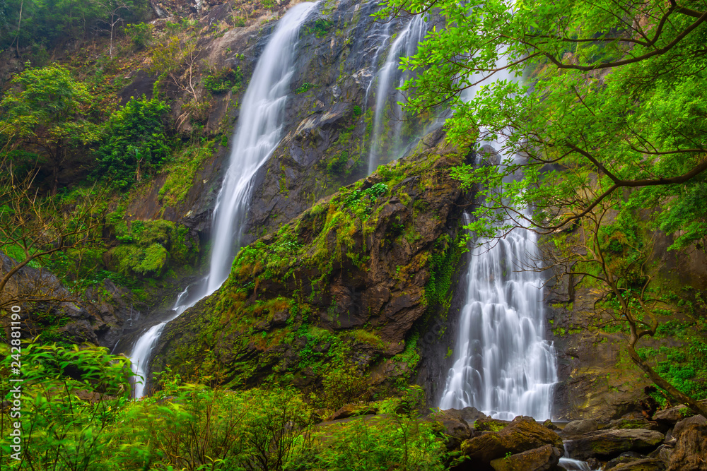 Obraz premium Khlong Lan Waterfall, the beautiful waterfall in deep forest at Khlong Lan National Park ,Kamphaeng Phet, Thailand,