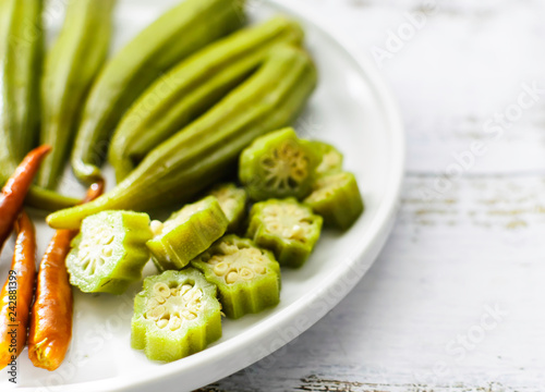 Pickled okra with peppers background photo