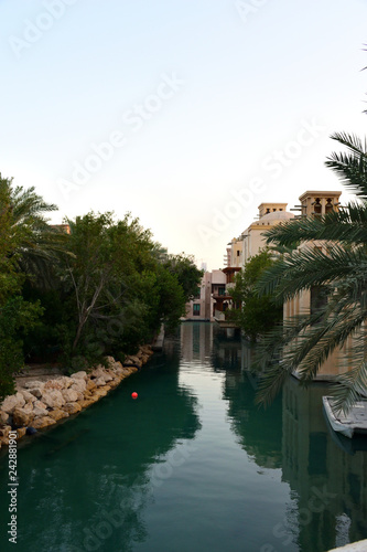 View of the artificial channel in the Arab city at sunset