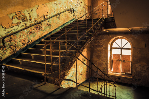 Dark staircase inside abandoned old factory building 