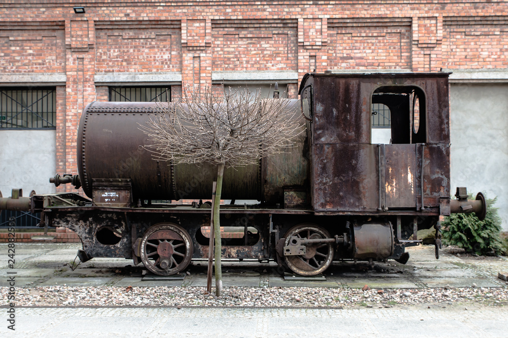 Old black lokomotive in Żyrardow (Poland) covered with rust.