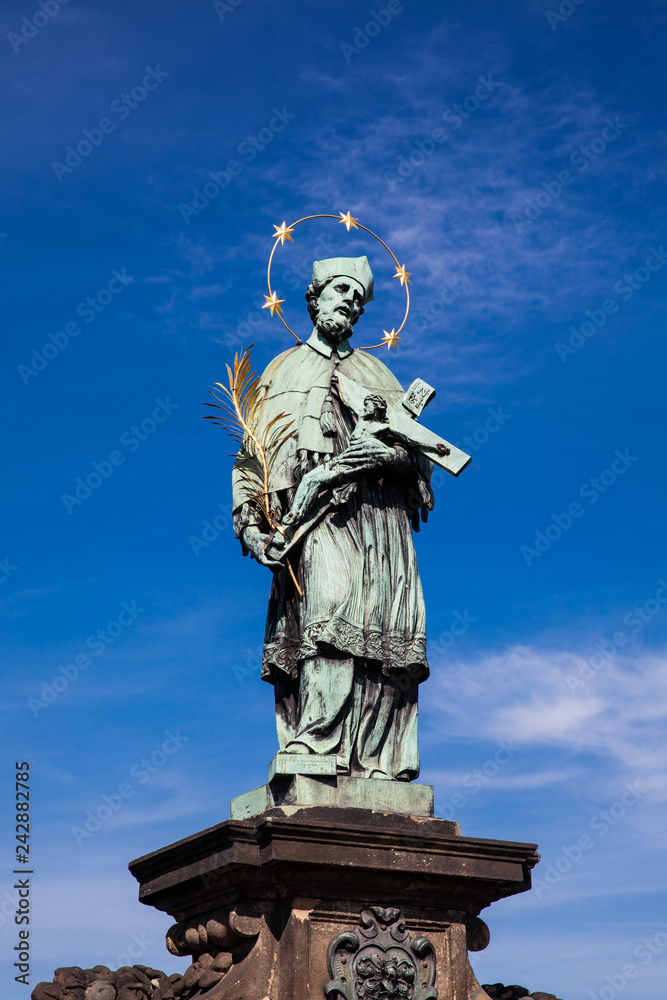 St. John of Nepomuk 1683 antique sculpture on the medieval gothic Charles Bridge in Prague