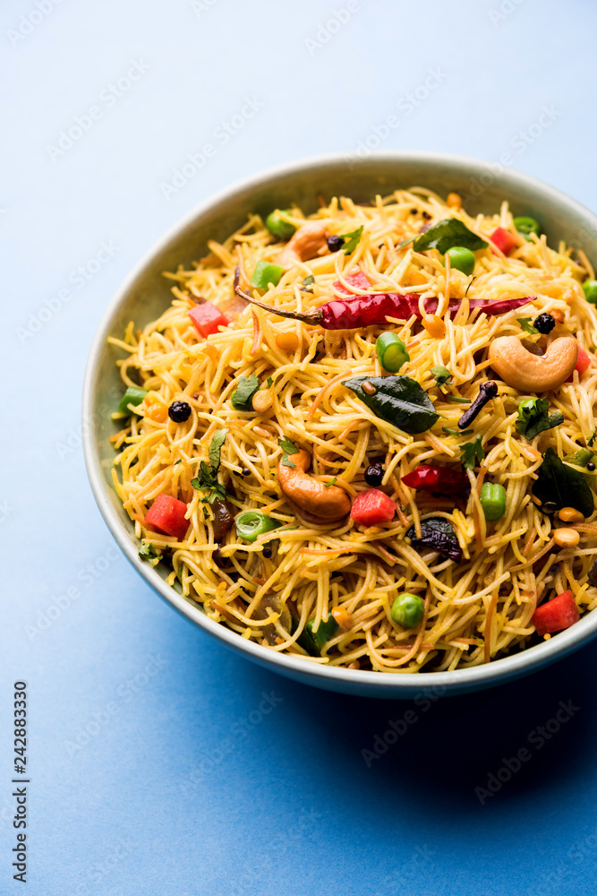 Spicy semiya uppma or upma served in plate. selective focus Spicy semiya uppma or upma served in plate. selective focus