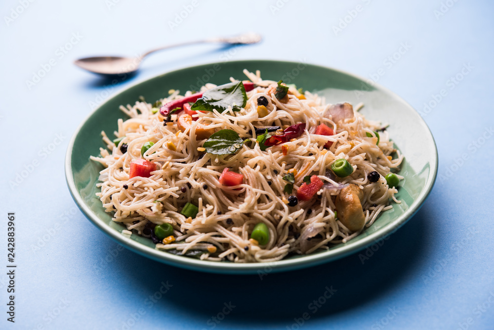 Spicy semiya uppma or upma served in plate. selective focus Spicy semiya uppma or upma served in plate. selective focus